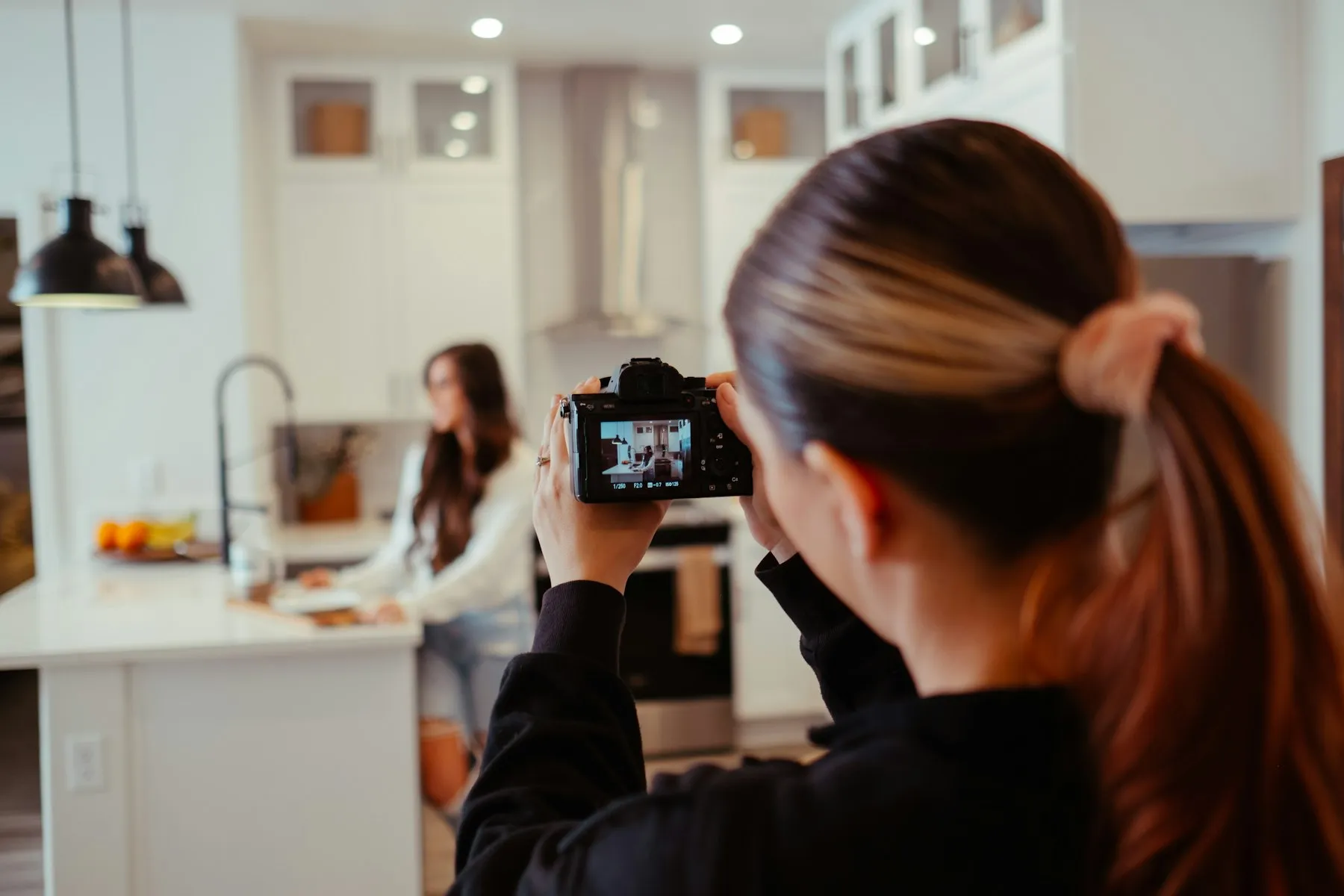 Creator filming a cooking video in a home kitchen