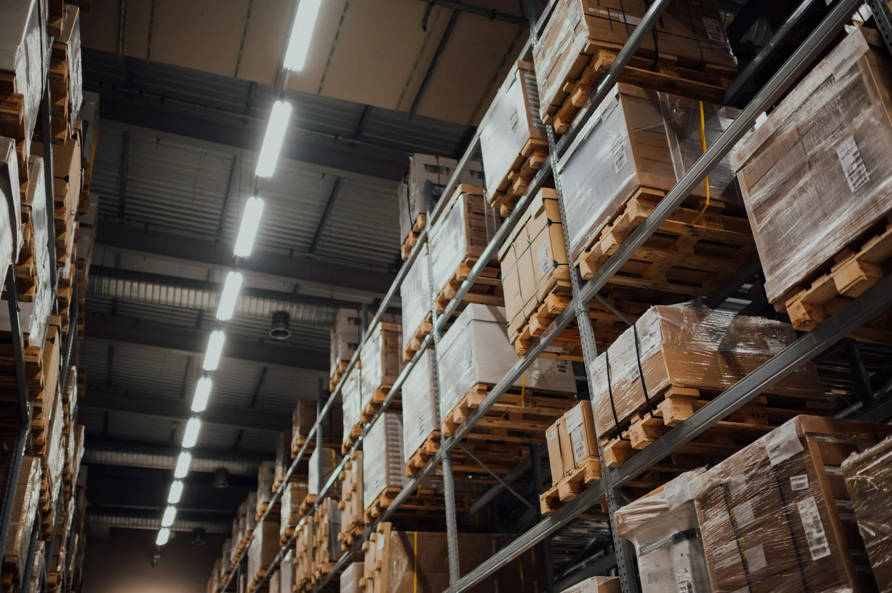 Long warehouse aisle with shelves full of boxed inventory